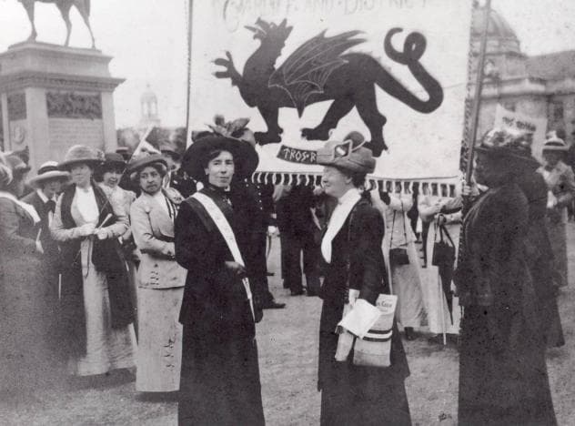 Women carrying the Cardiff and District Women's Suffrage Society banner in Cathays Park in 1913