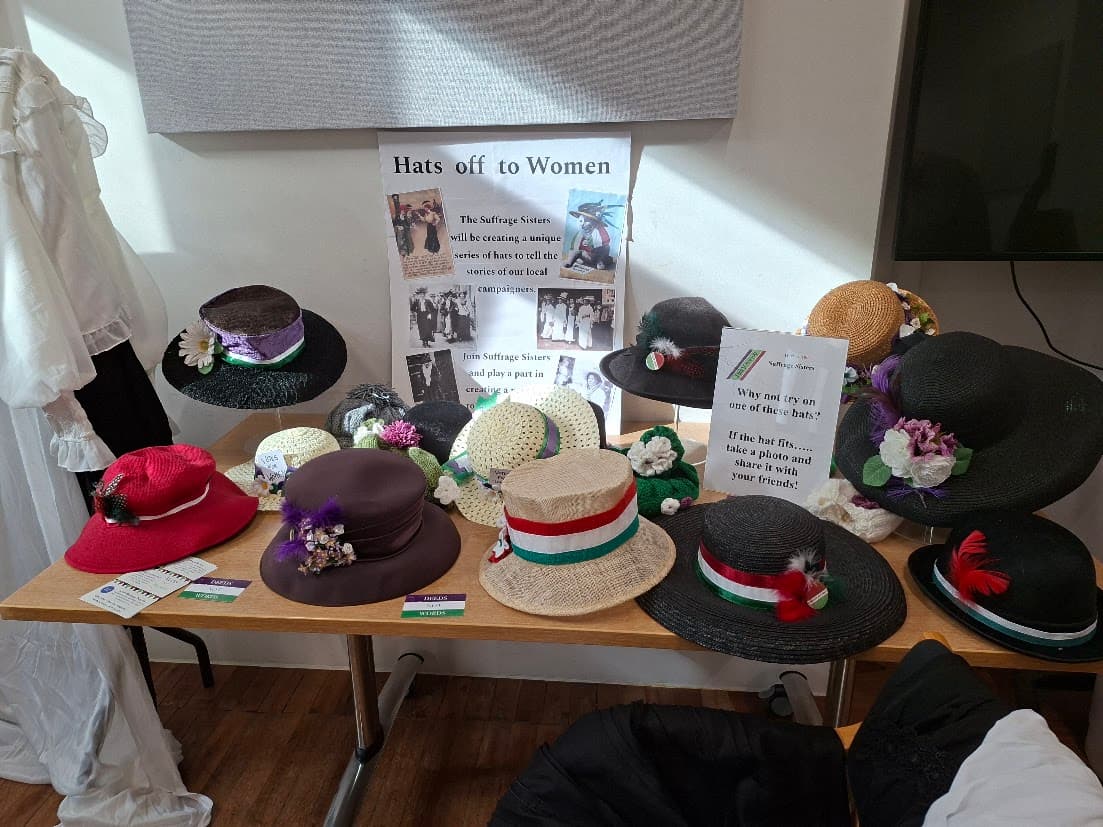 A display of suffrage-inspired hats at the Suffrage Sisters launch